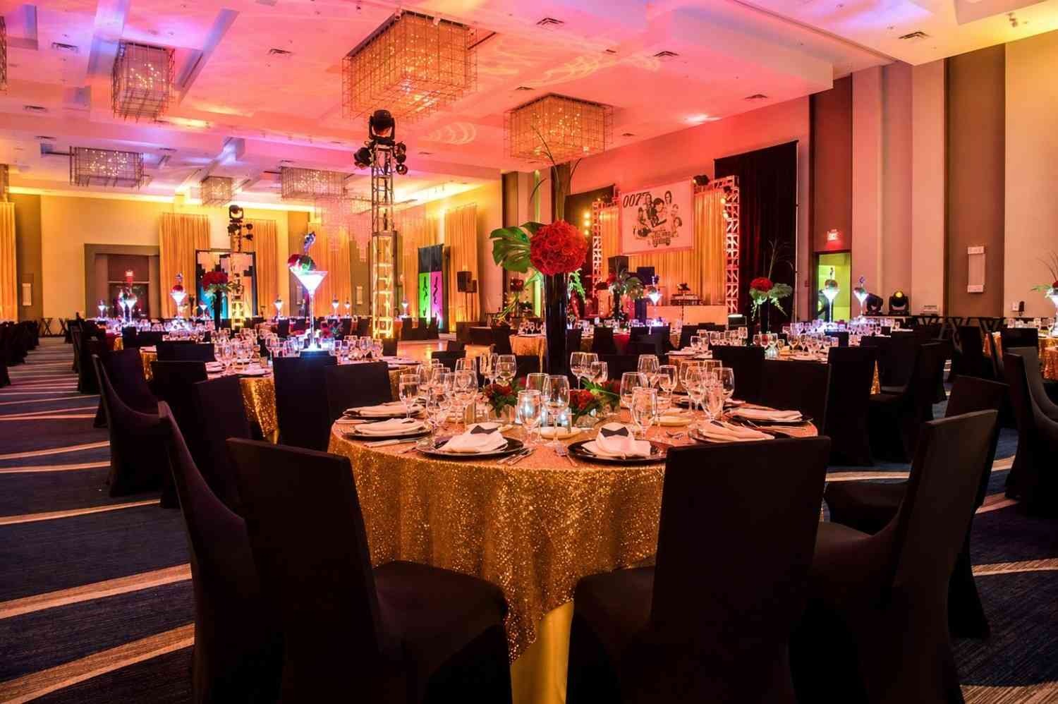 Luxury banquet hall with round dining tables, elegant lighting, and premium d&eacute;cor setup for a wedding reception event.