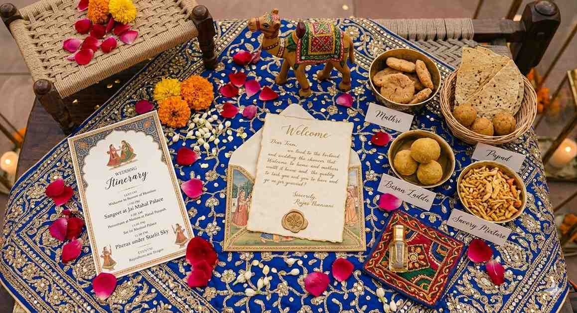 Rajasthan wedding welcome hamper flatlay on royal blue embroidered cloth