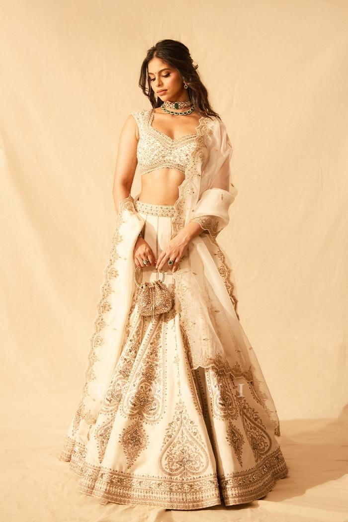 Baeutifull Bridal lehenga in ivory and gold with delicate threadwork, classic motifs, and a sophisticated contemporary silhouette.