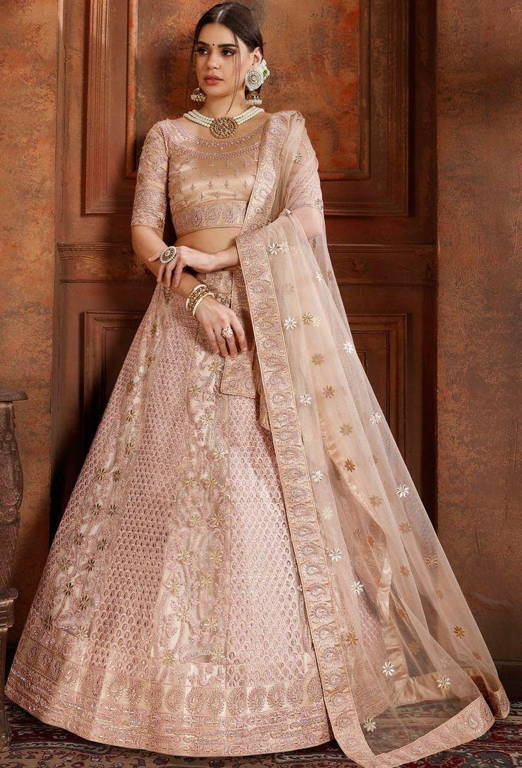 Wedding Bridal lehenga in metallic pastel tones with mirror embellishments and multicolored panel detailing for a trendy bridal style.