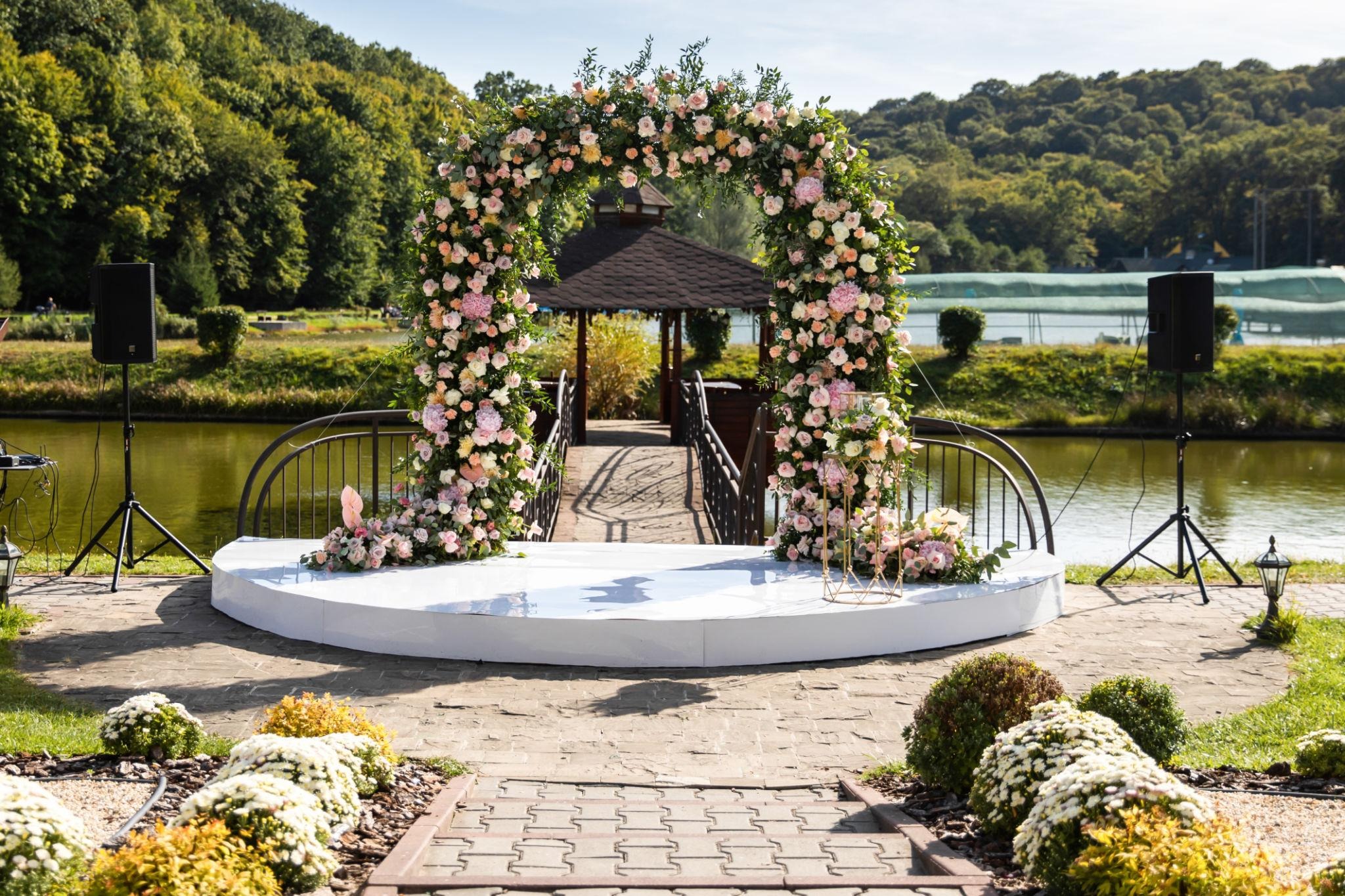 Luxurious wedding mandap decorated with vibrant flowers, elegant lighting, customized stage setup, and premium d&eacute;cor elements for a grand Indian wedding celebration.