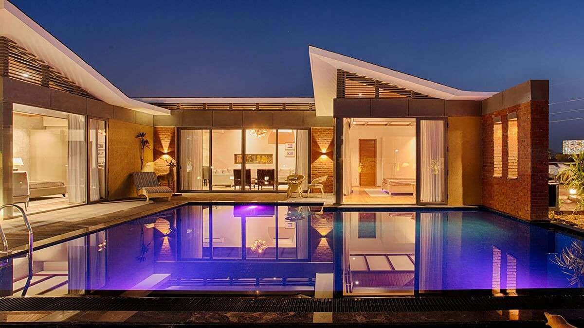Elegant farm resort entrance with landscaped gardens and grand architectural design