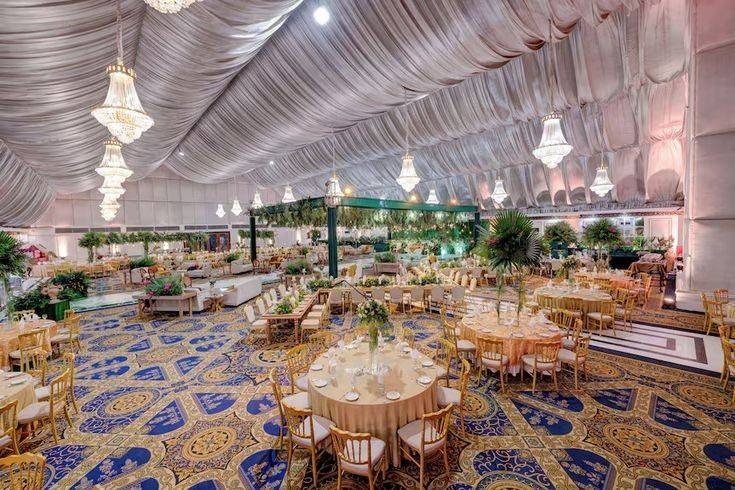 Luxury indoor wedding banquet hall with elegant chandelier lighting, premium seating arrangements, floral décor, and grand event setup for weddings and receptions in Delhi NCR.