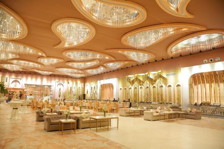 Luxury banquet hall with modern chandelier ceiling design, elegant seating arrangements, spacious event area, and premium décor for weddings, receptions, engagements, and corporate events in Delhi NCR.