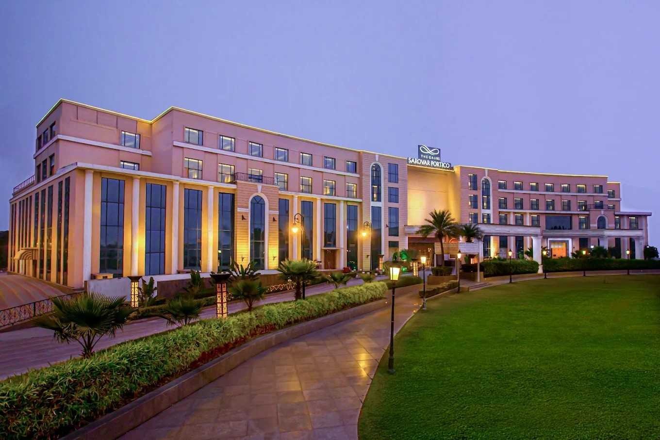 The Gaurs Sarovar Portico hotel and banquet in Greater Noida featuring a luxury wedding venue with landscaped gardens, premium event spaces, and elegant architecture.