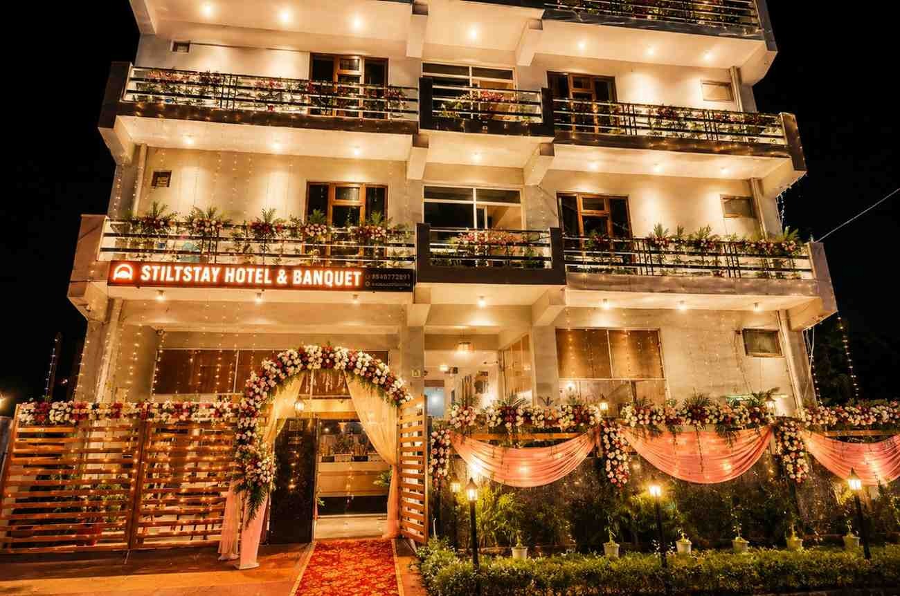 Beautifully decorated StiltStay Hotel & Banquet wedding venue with elegant floral entrance, warm lighting, and luxury outdoor d&eacute;cor for weddings, receptions, engagements, and celebrations in Delhi NCR.