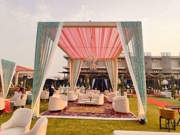 Elegant outdoor wedding lawn with luxury lounge seating, floral canopy, and stylish d&eacute;cor for weddings, receptions, and engagement celebrations.